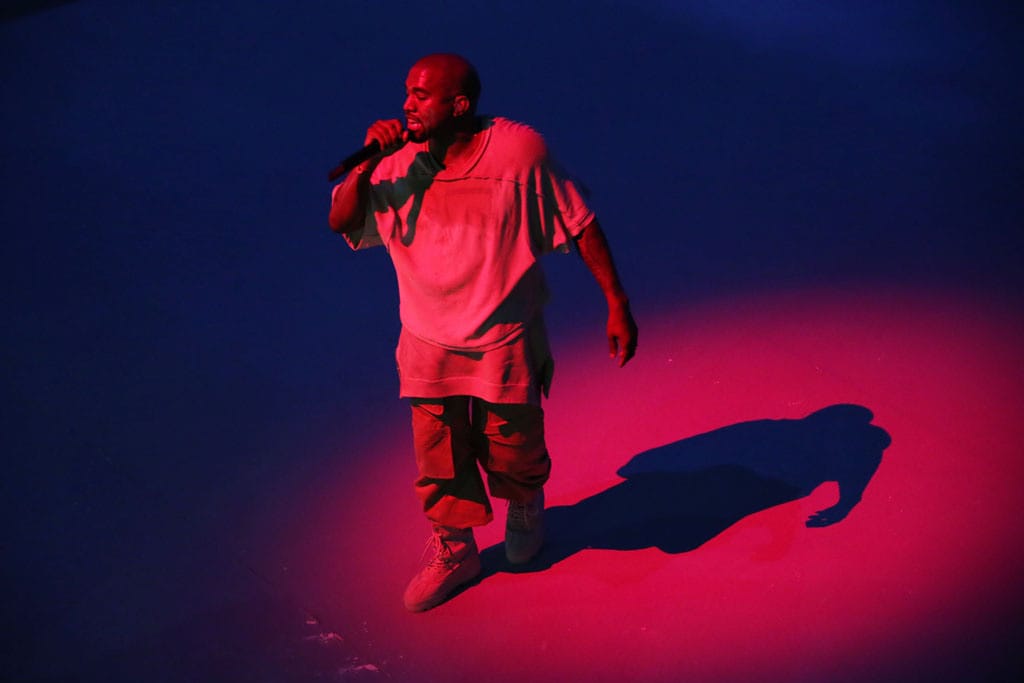 Kanye West performing at the Louis Vuitton Foundation.